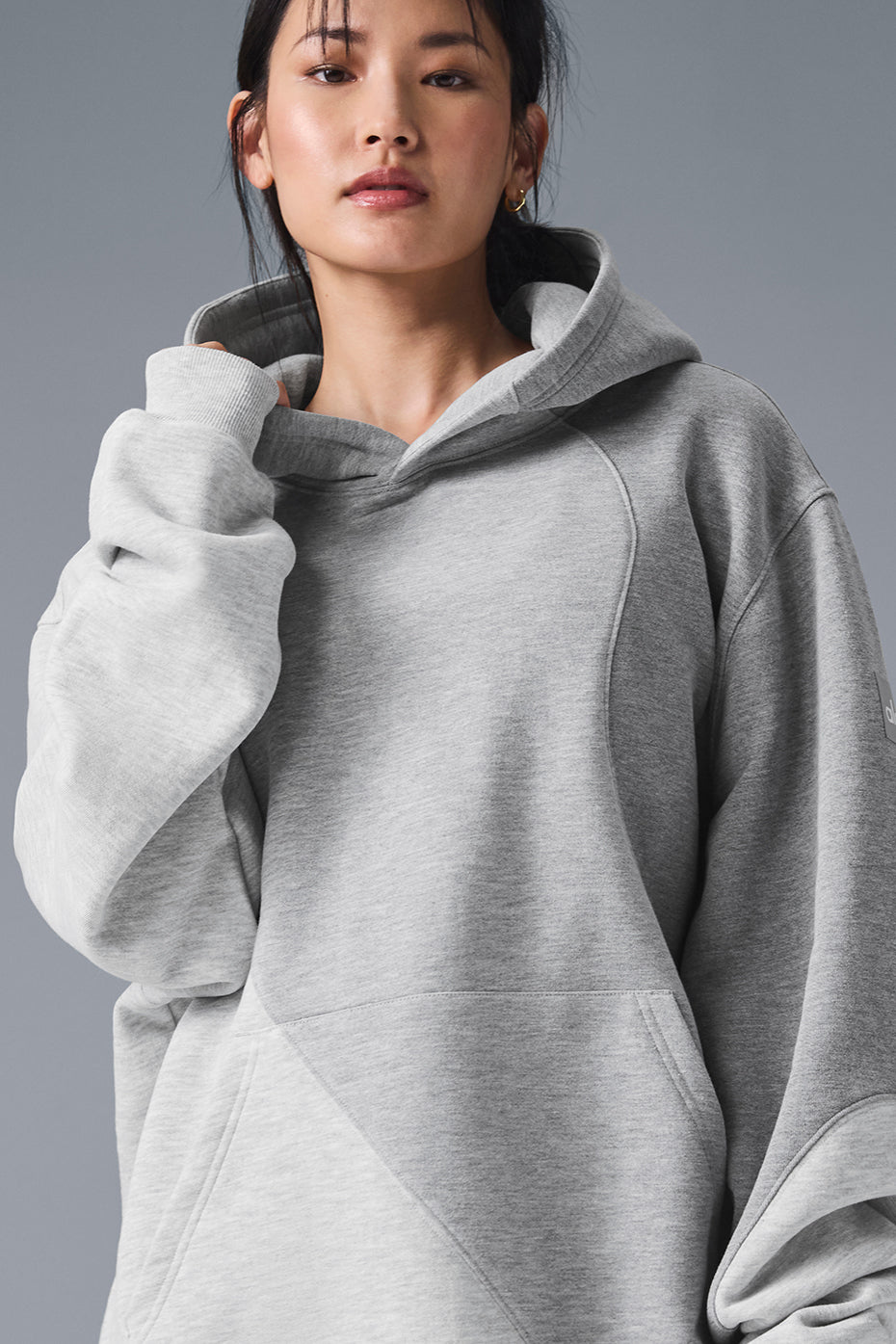 Front view of oversized french terry hoodie in Heather Grey with wave pattern detail