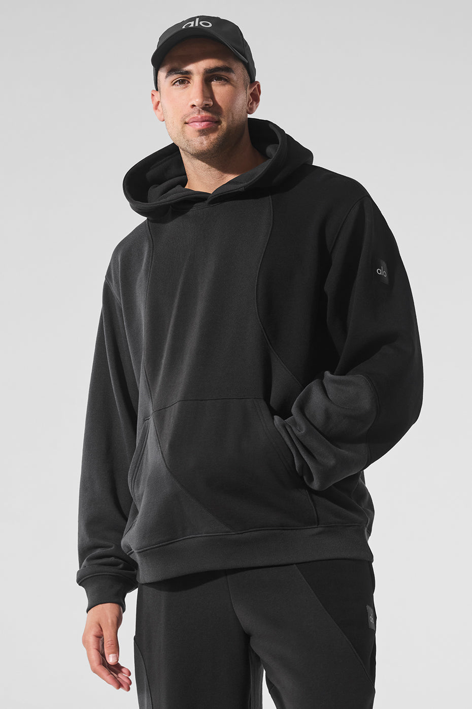 Front view of oversized comfort hoodie styled with neutral joggers in urban setting.