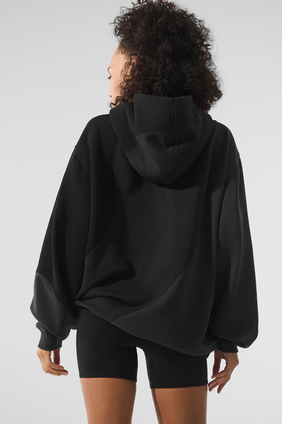 Side view of the oversized black hoodie, ideal for layering.