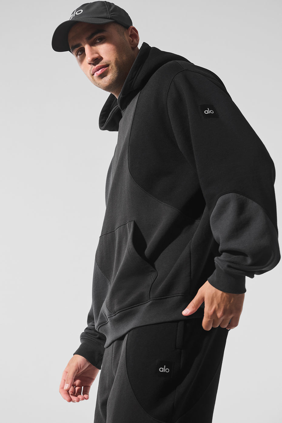 Front view of oversized comfort hoodie styled with neutral joggers in urban setting.