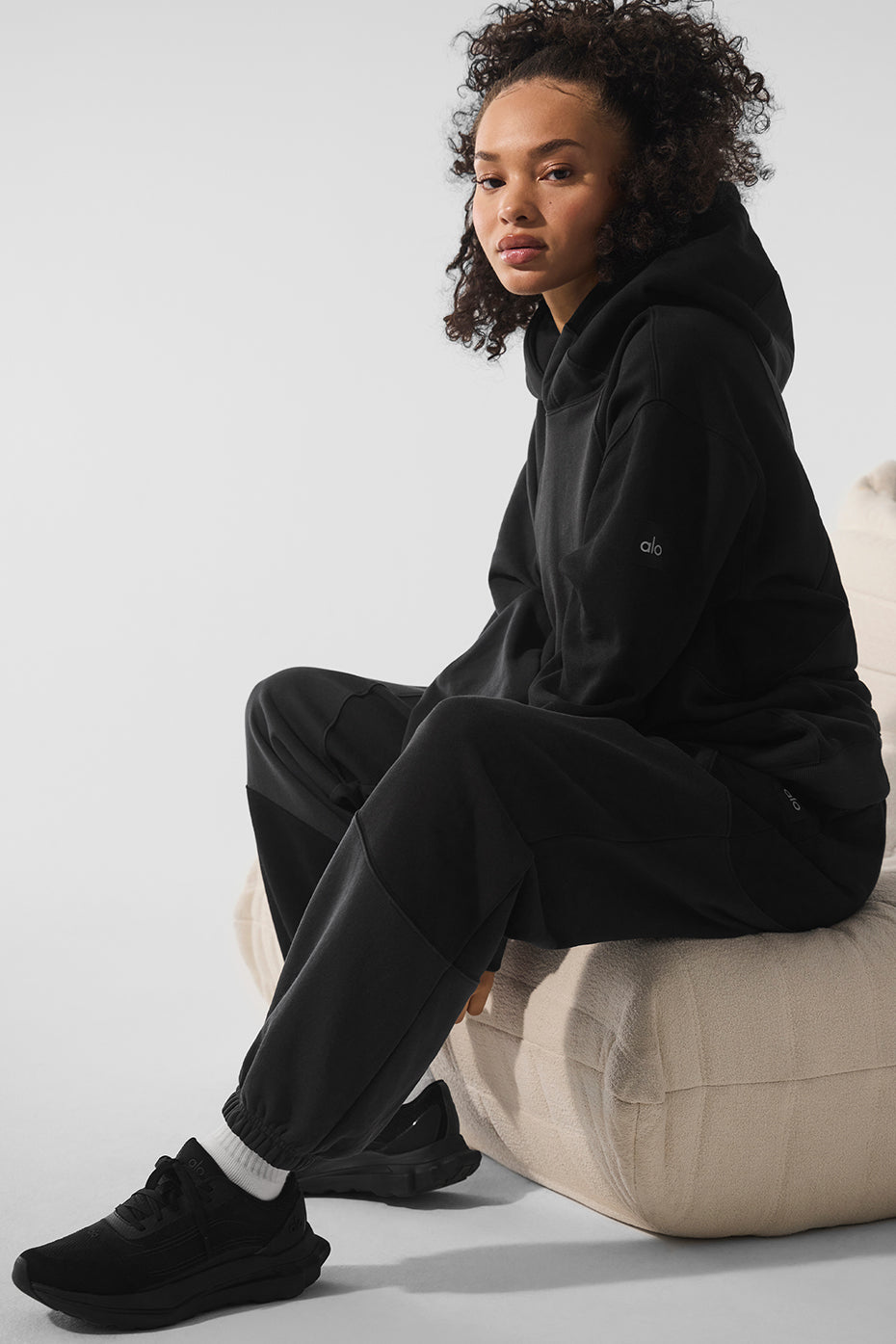 Side view of the oversized black hoodie, ideal for layering.