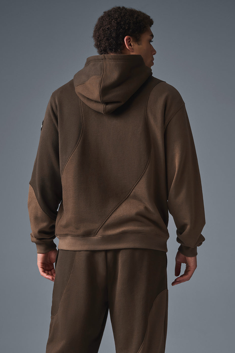 Side view of the oversized zip-up hoodie, highlighting the unique wave pattern.