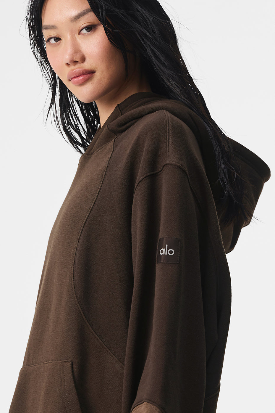 Womens oversized hoodie version styled with matching neutral tone sweatpants outdoors.