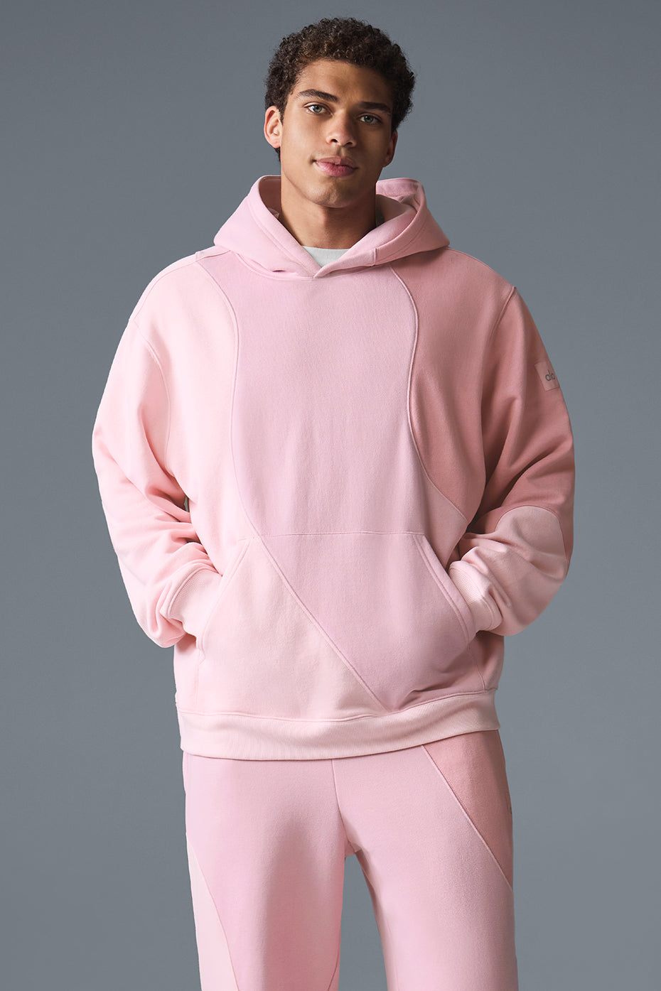 Front view of the Sunset Pink Comfort Hoodie on a model in a casual setting.