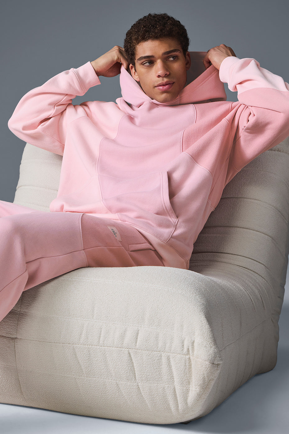 Front view of the Sunset Pink Comfort Hoodie on a model in a casual setting.