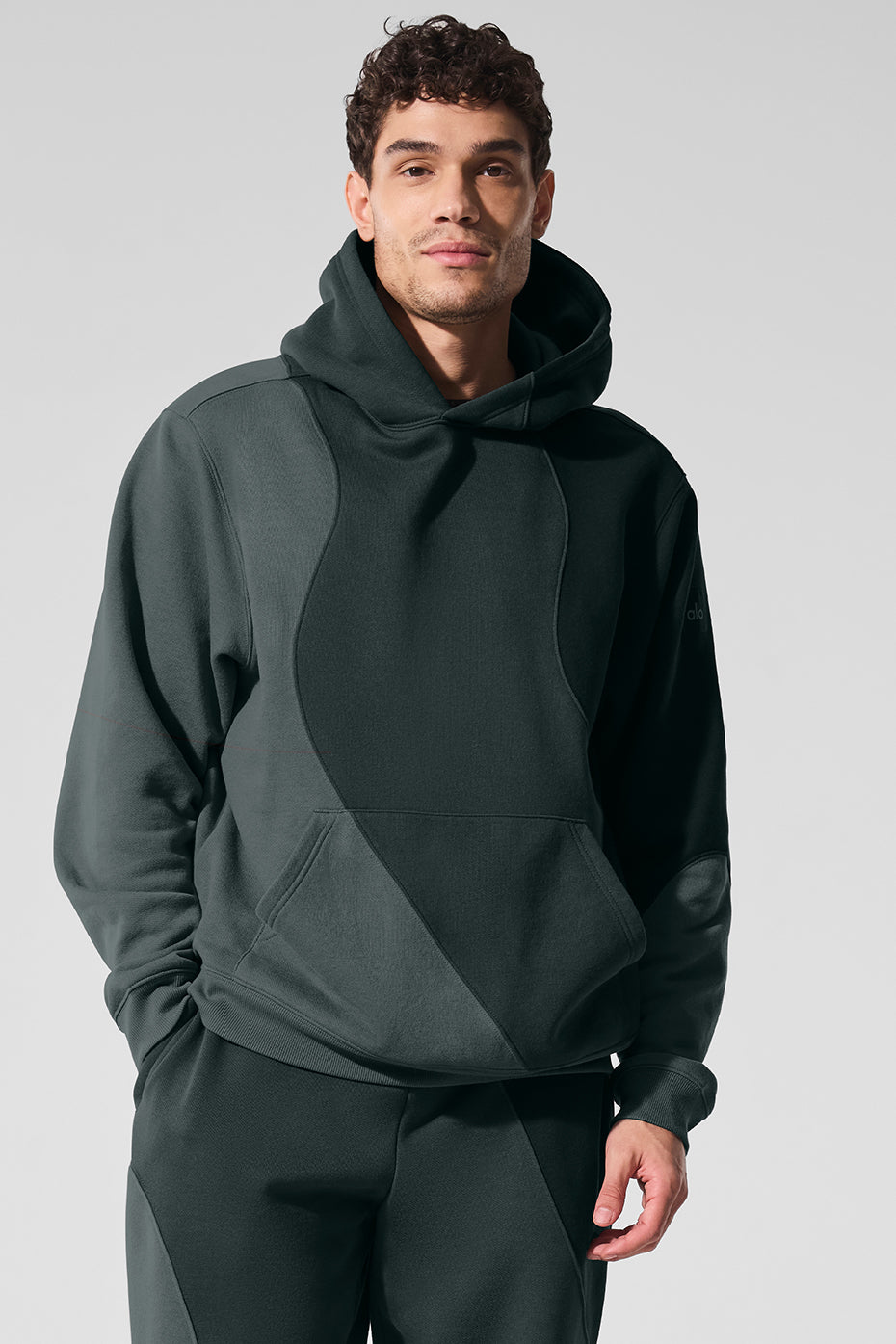 Front view of the oversized hoodie in charcoal green, showcasing its soft fabric.