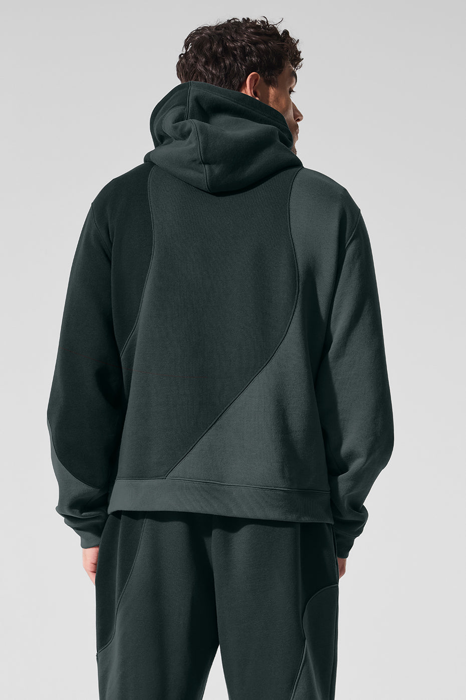 Side view of the oversized zip up hoodie, highlighting the unique wave pattern.