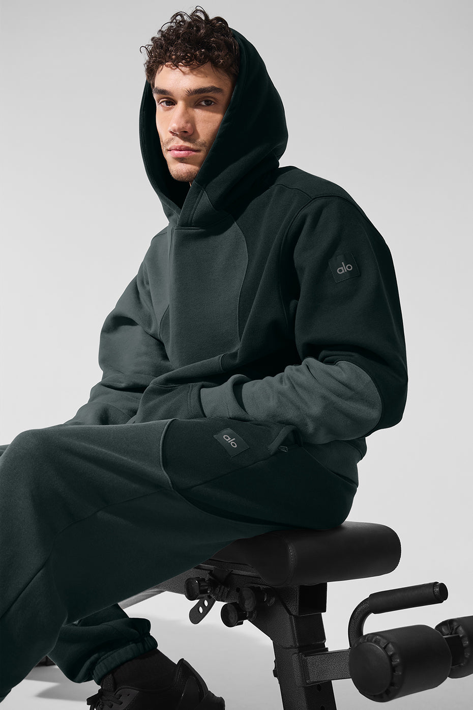 Front view of the oversized hoodie in charcoal green, showcasing its soft fabric.