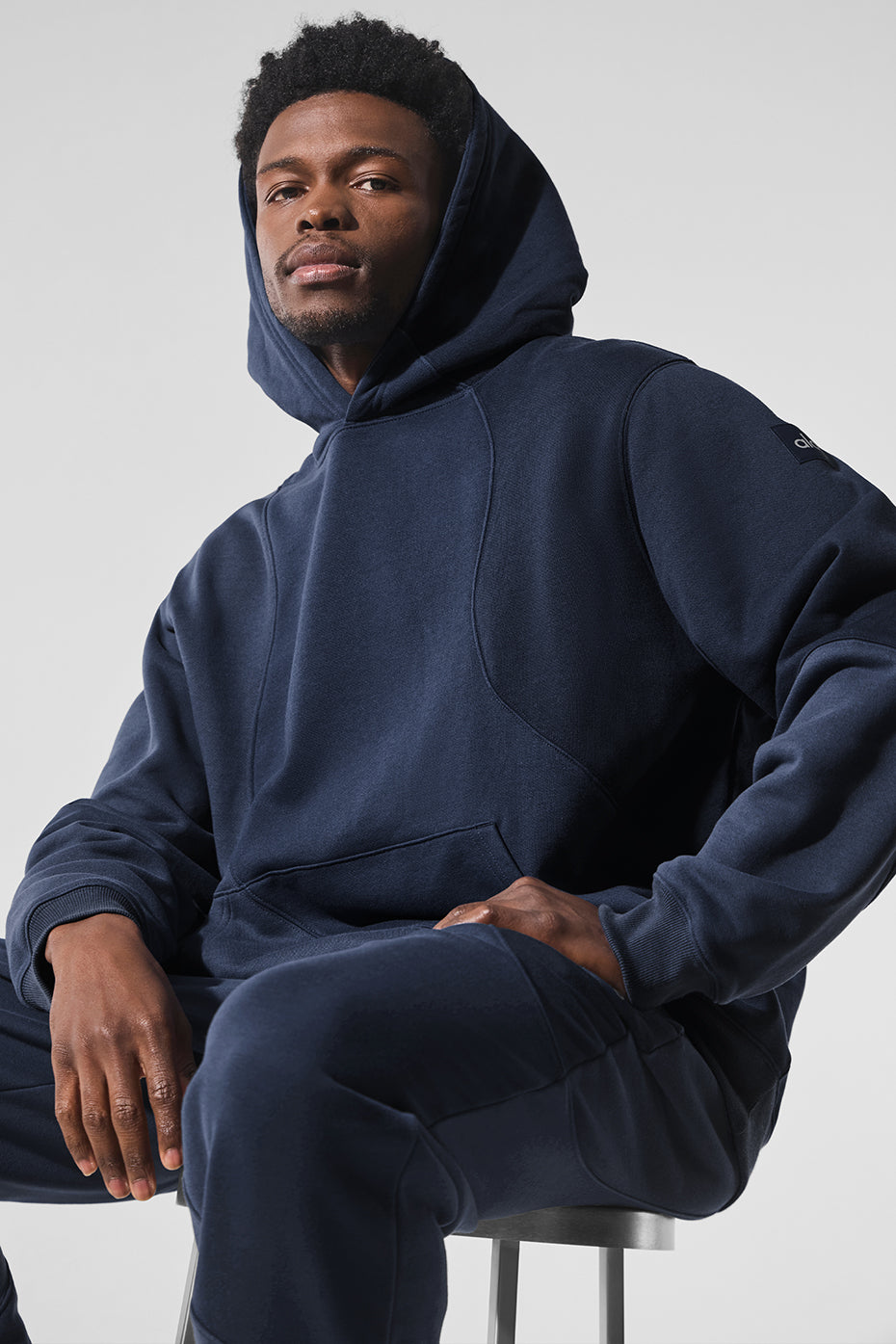 Close-up of French terry fabric texture on navy oversized hoodie