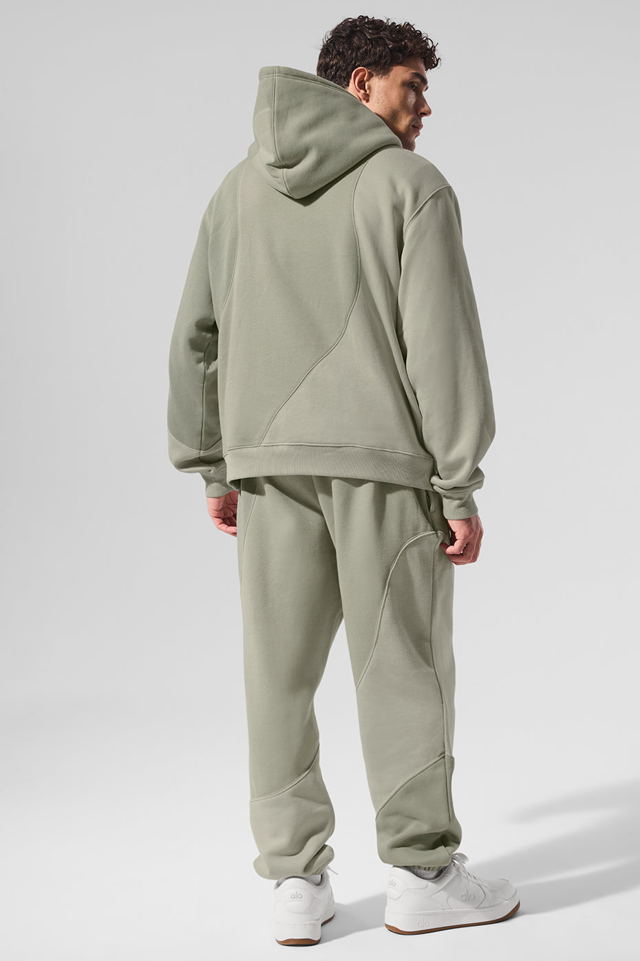 Model wearing the oversized zip-up hoodie in a casual street setting.