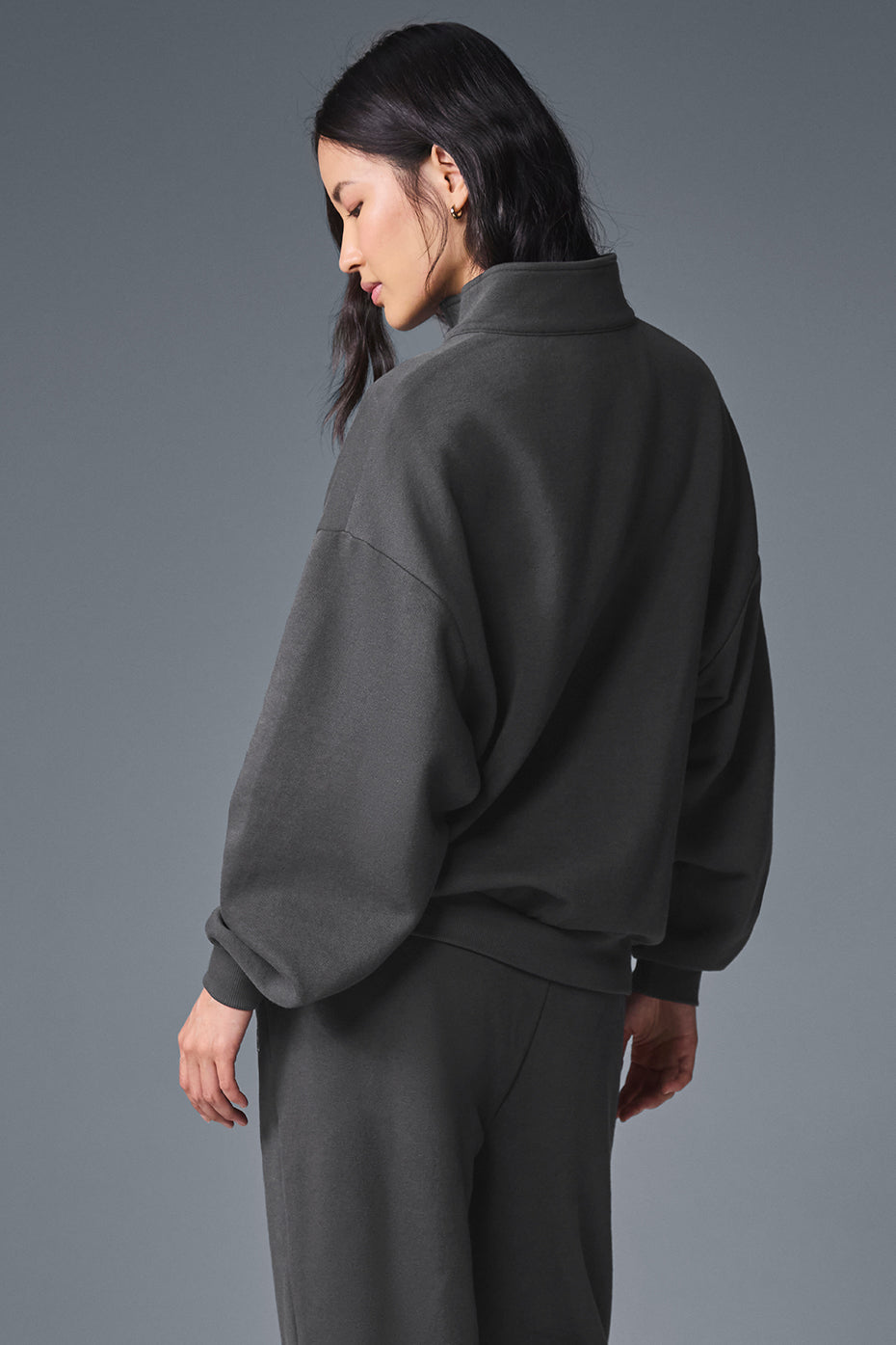 Layered outfit featuring grey 1/4 zip sweatshirt for transitional weather