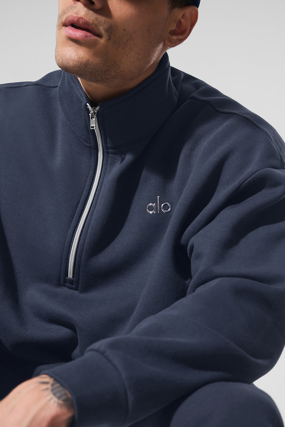 Close-up of the quarter zip detail on a navy pullover for men