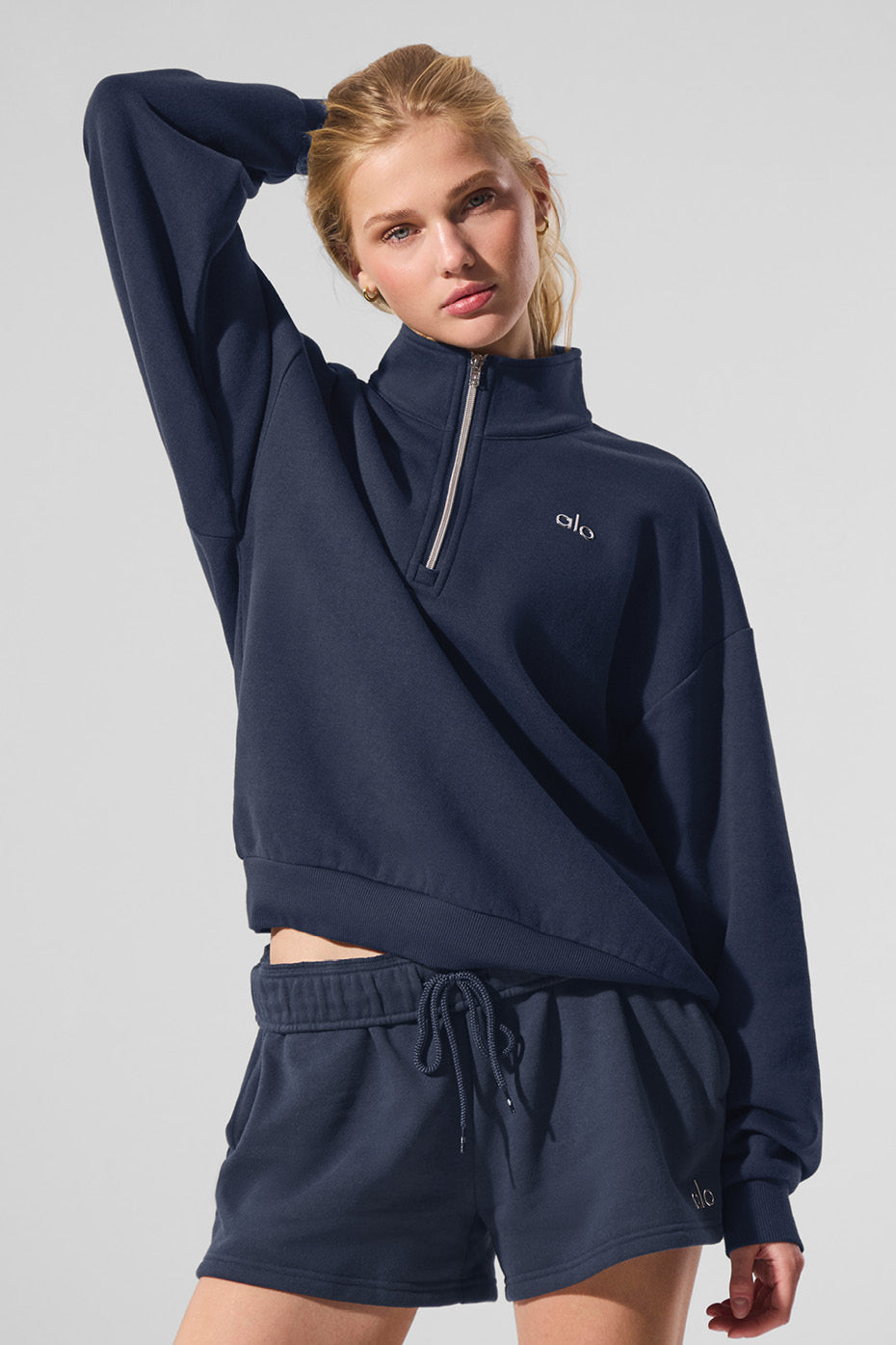 Side view showcasing the stylish collar of the navy pullover sweater.