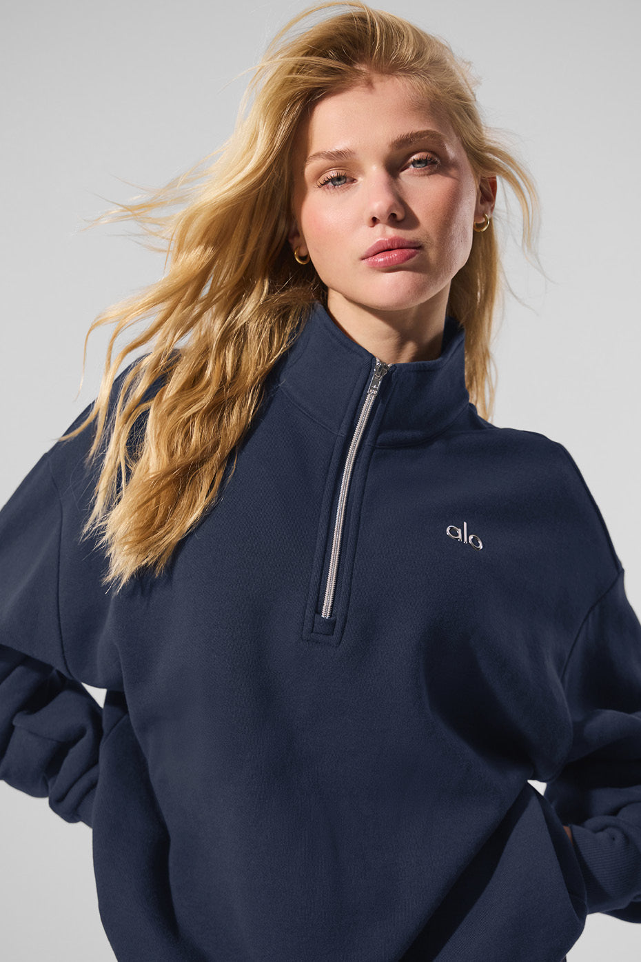 Side view showcasing the stylish collar of the navy pullover sweater.