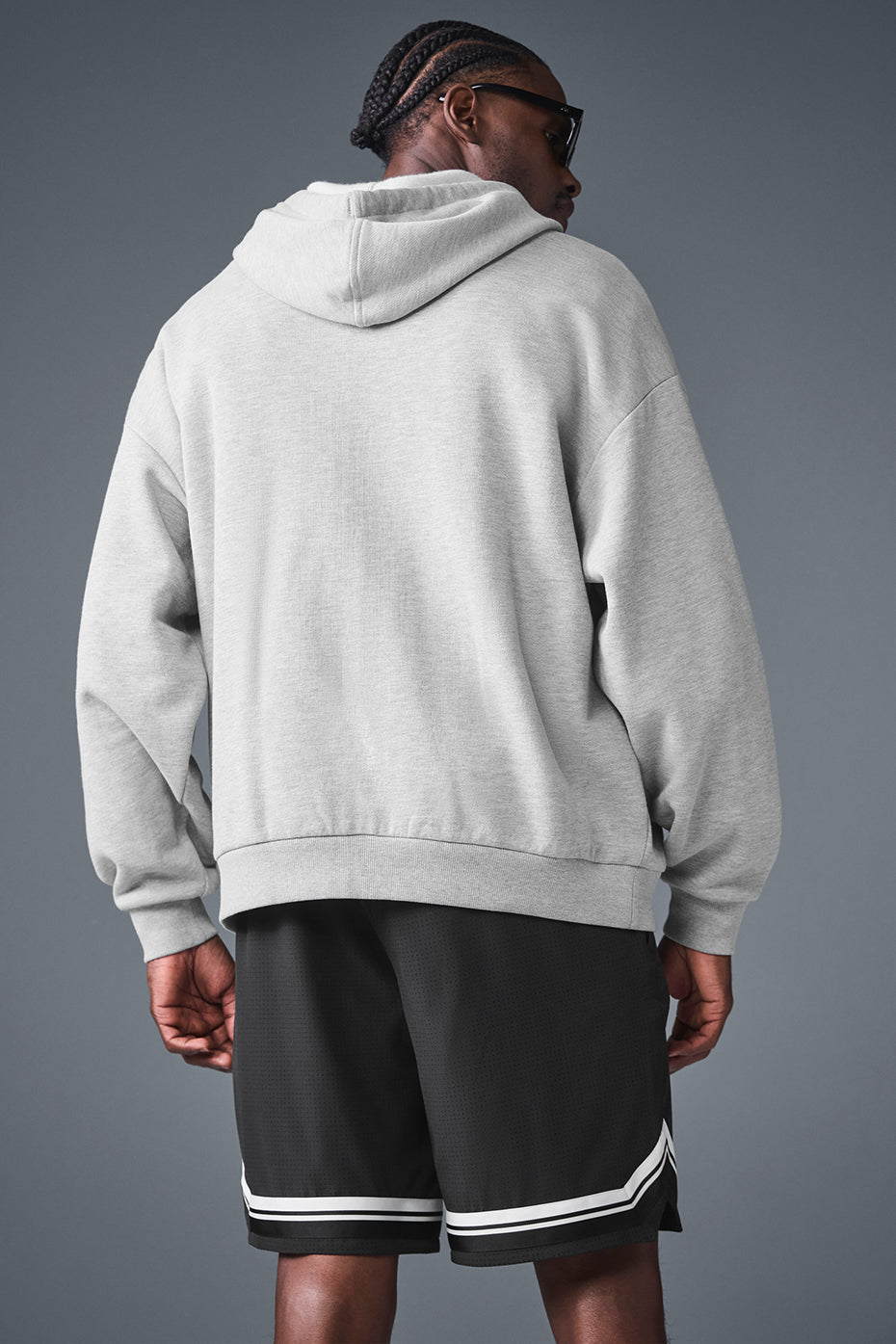 Model wearing the unisex hoodie during a casual outing.