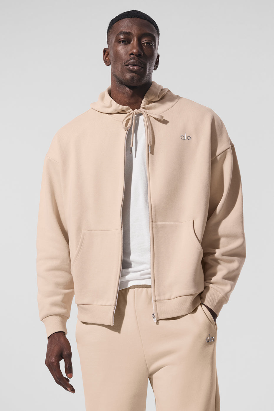 Front view of the macadamia zip up hoodie, showcasing its oversized fit and French terry fabric.