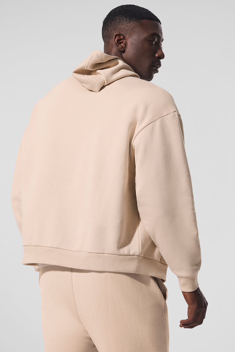Side view of the black zip up hoodie, highlighting its cozy design and stylish silhouette.