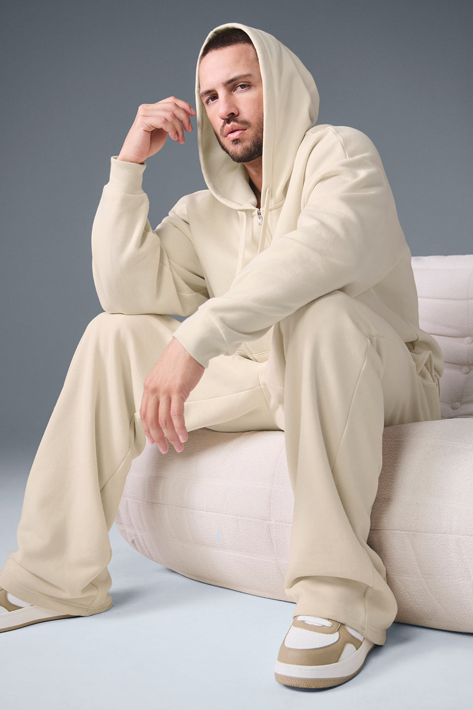 Unisex model wearing oversized zip up hoodie with urban backdrop