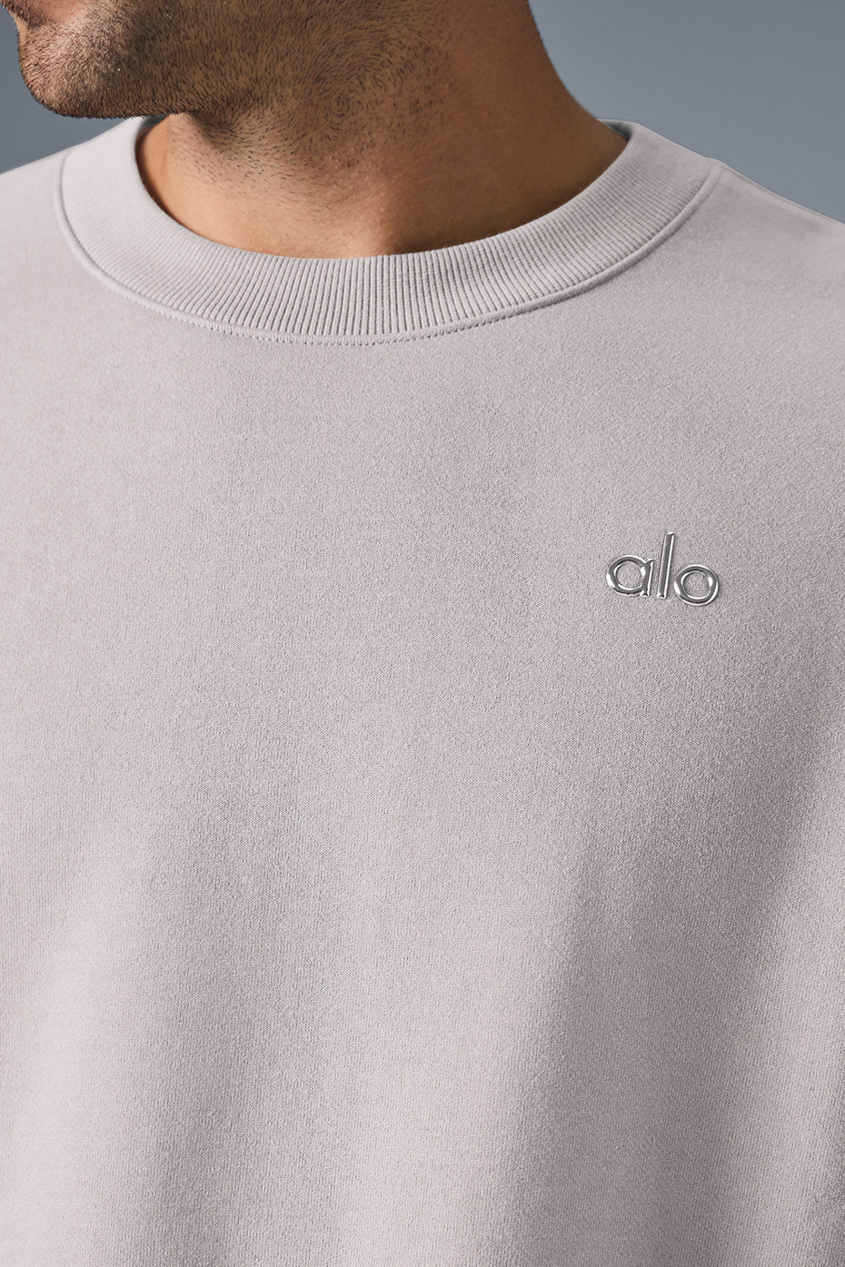Detail of the ribbed hem and cuffs on the French terry pullover for men in a casual setting