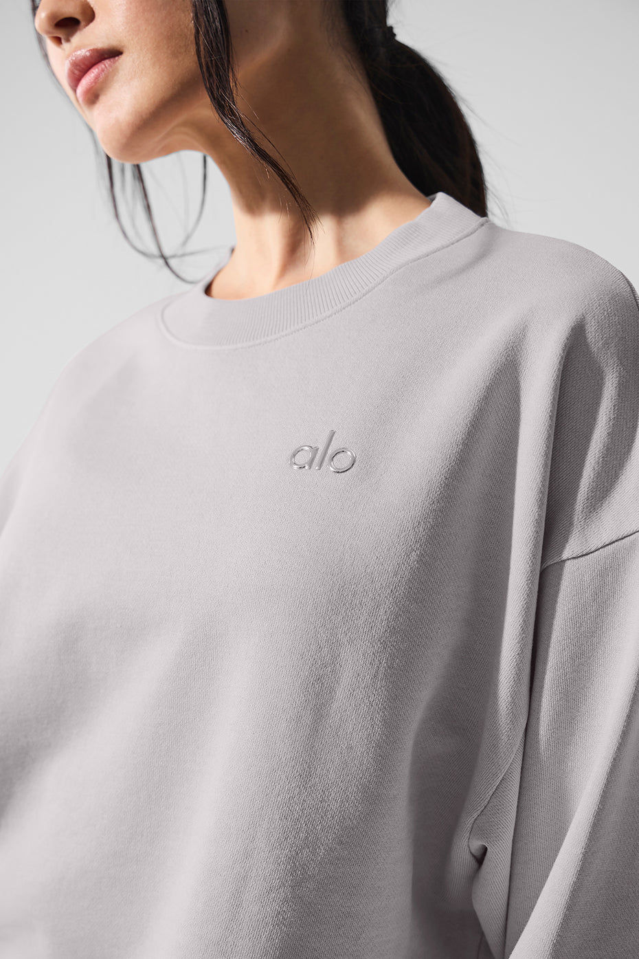 Front view of the washed grey sky womens crew neck pullover styled with leggings for casual wear