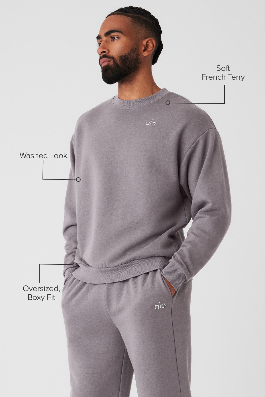 Side view of the black crew neck pullover, highlighting the ribbed cuffs and hem.