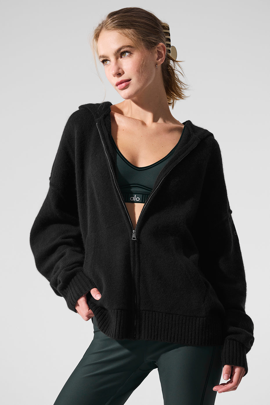 Black cashmere zip hoodie on a model, showcasing relaxed fit.