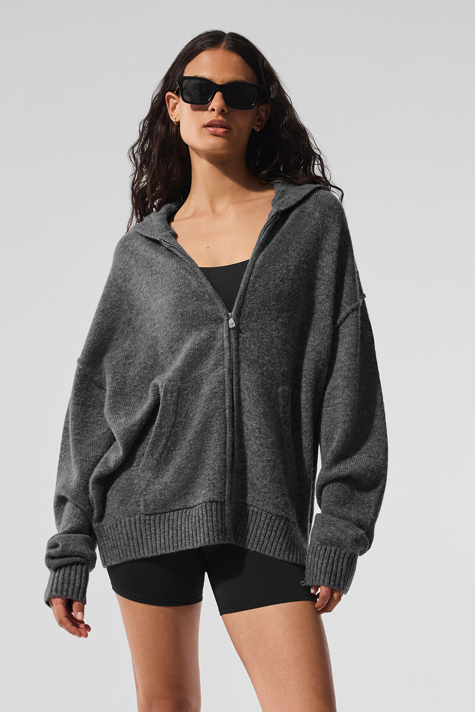 Platinum grey cashmere zip hoodie worn casually outdoors