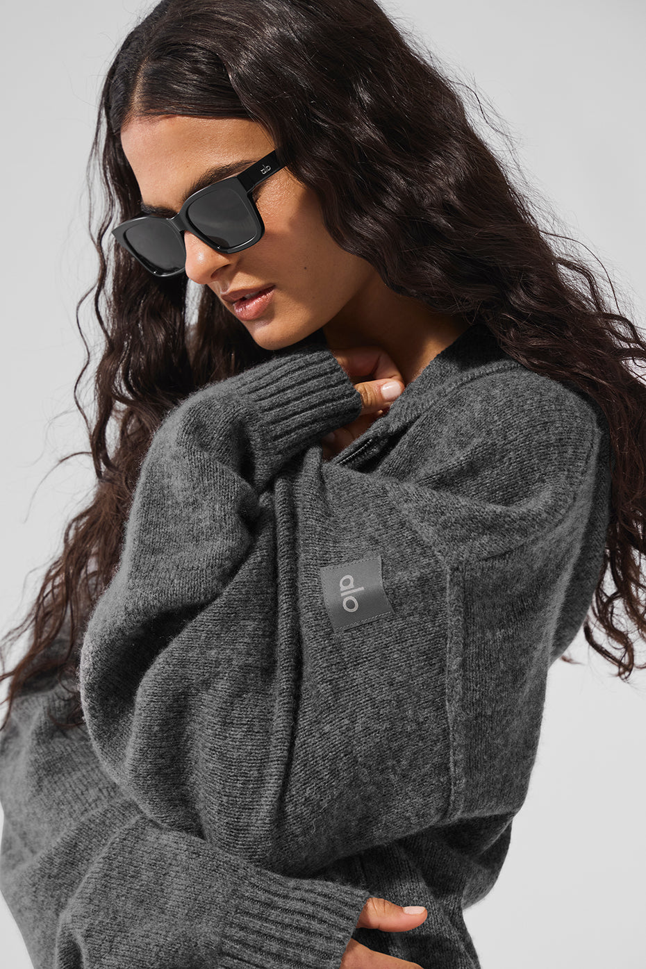 Platinum grey cashmere zip hoodie worn casually outdoors