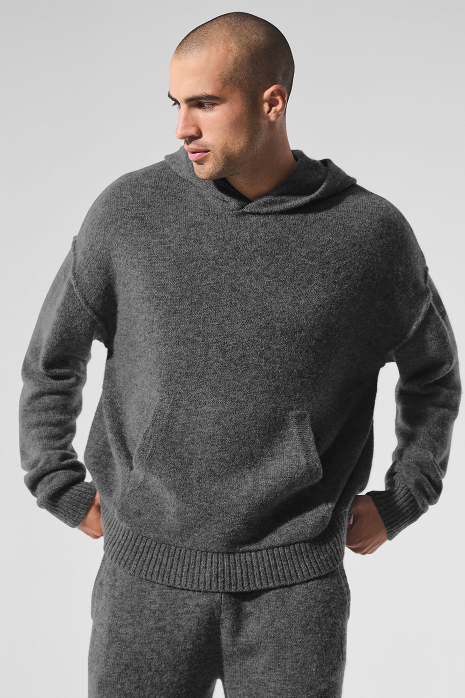Close-up of the luxurious cashmere fabric on a women's hoodie in grey