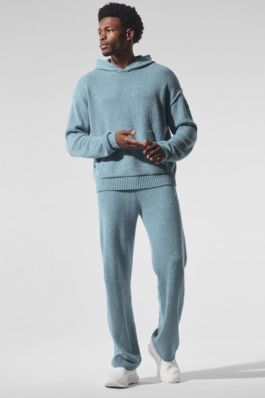 Model wearing cashmere zip hoodie in a cozy home setting.