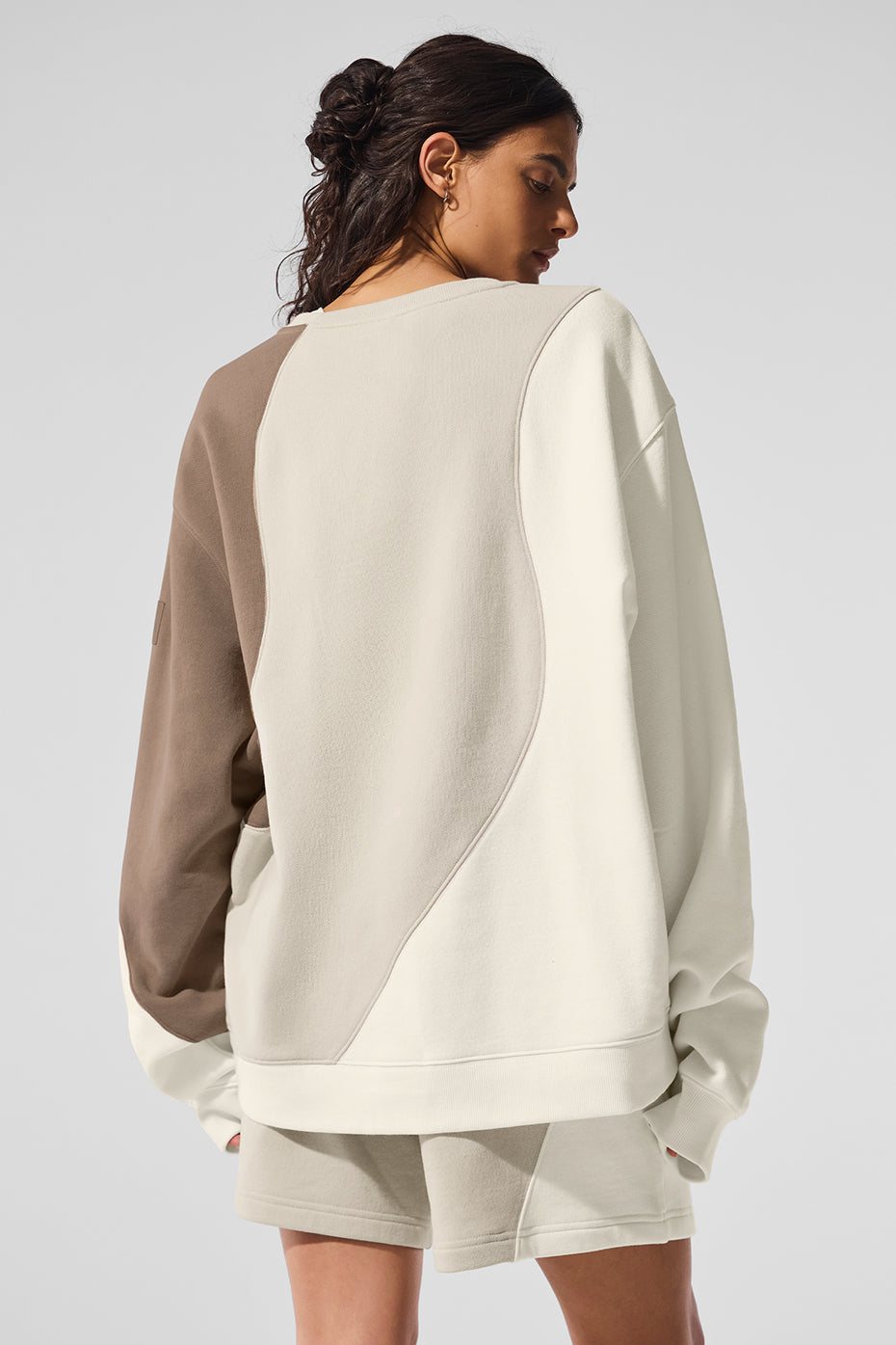 Side view showcasing the oversized fit of the crewneck sweatshirt.