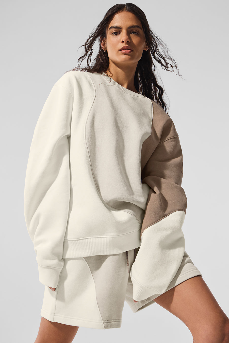 Side view showcasing the oversized fit of the crewneck sweatshirt.