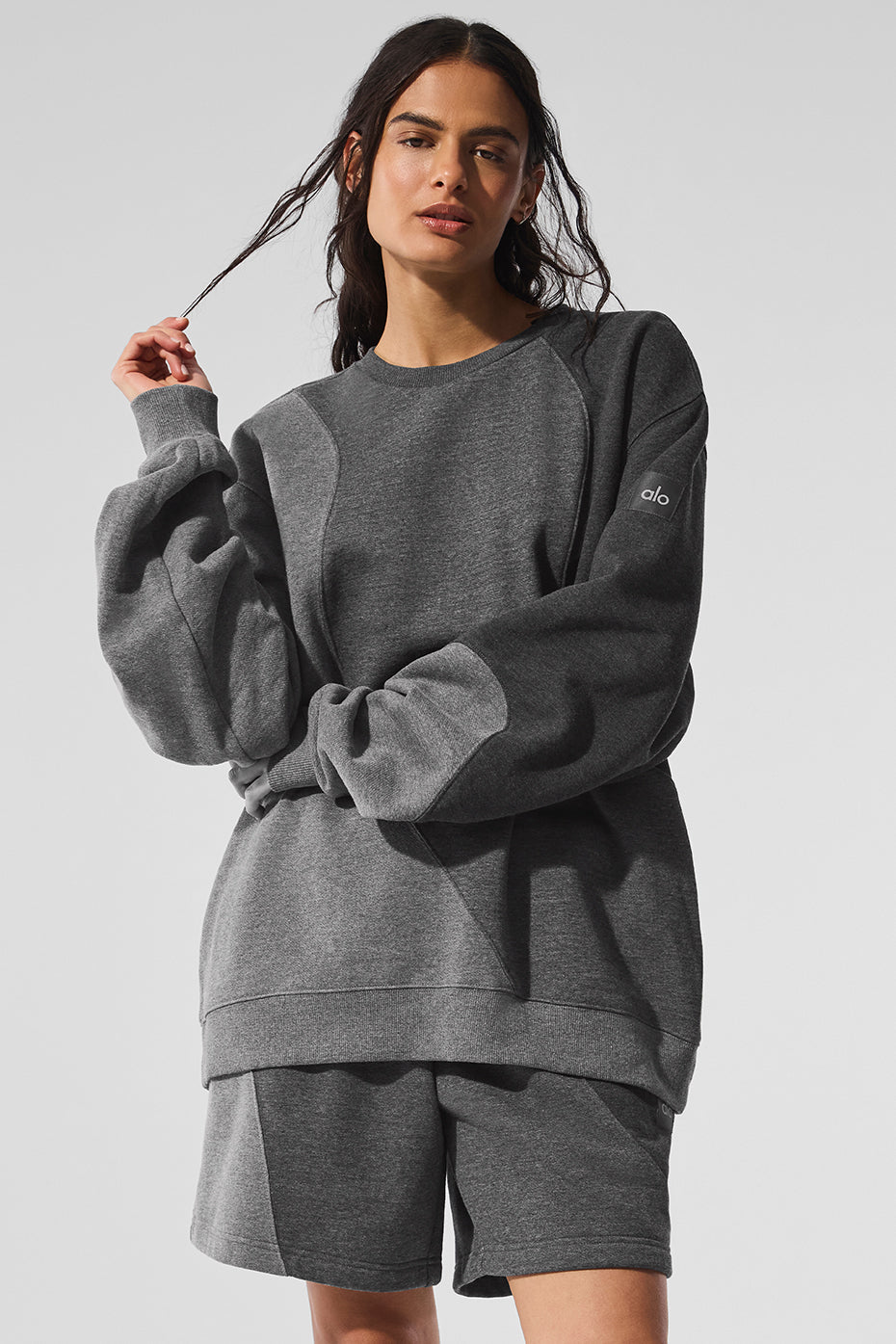 Close-up of the Make Waves crewneck pullover in dark heather grey showing soft fleece interior