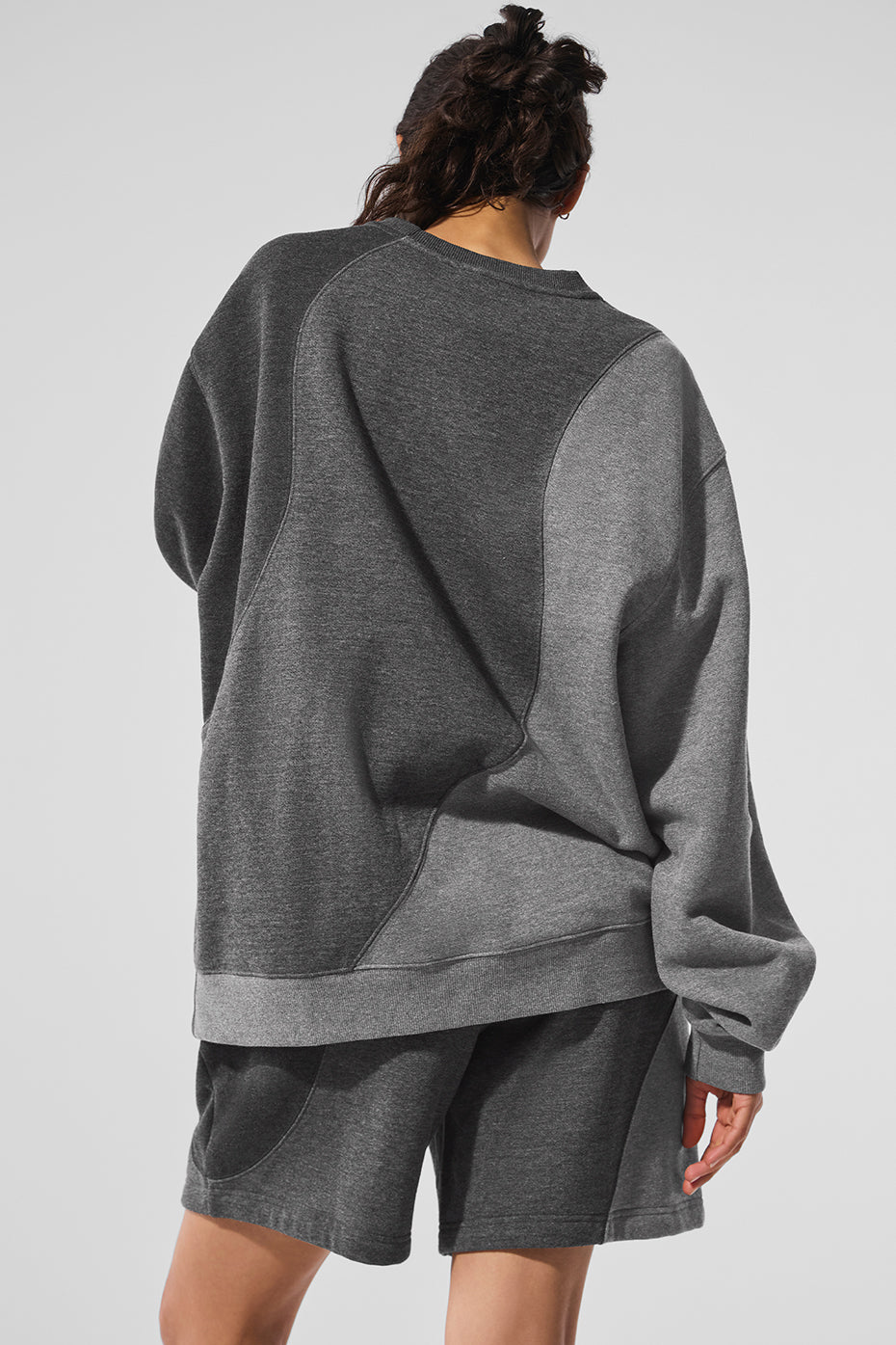 Model casually dressed in the Make Waves crewneck pullover paired with sweatpants for relaxed weekend wear