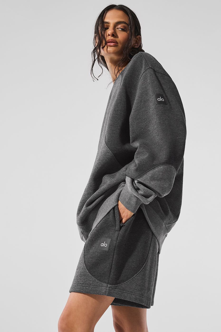Close-up of the Make Waves crewneck pullover in dark heather grey showing soft fleece interior