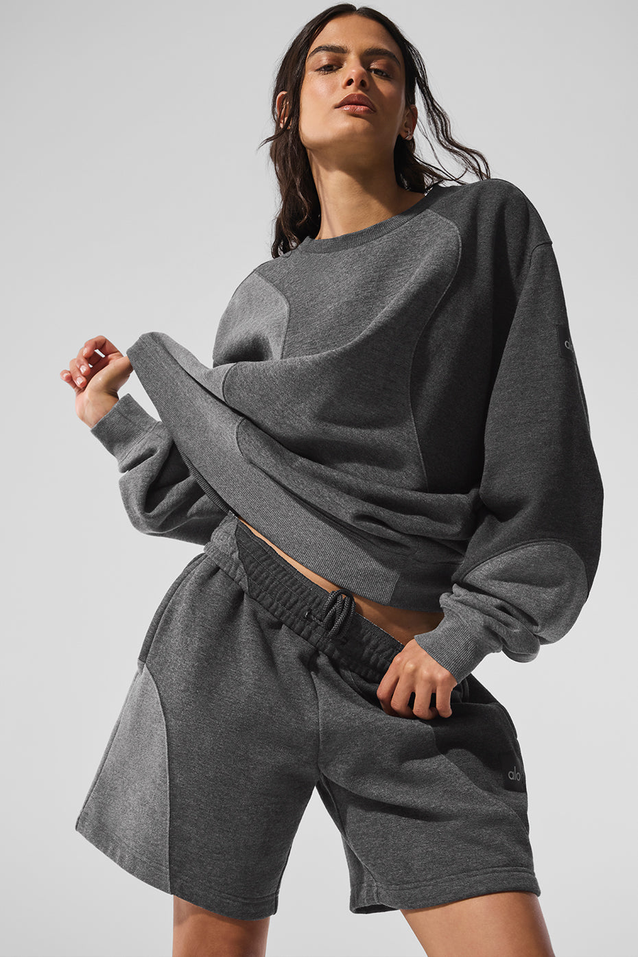 Model casually dressed in the Make Waves crewneck pullover paired with sweatpants for relaxed weekend wear