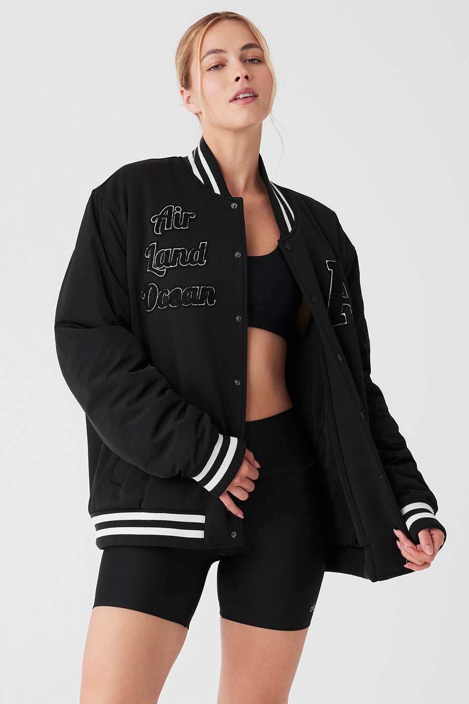 Front view of the black bomber jacket showcasing its unique patches.