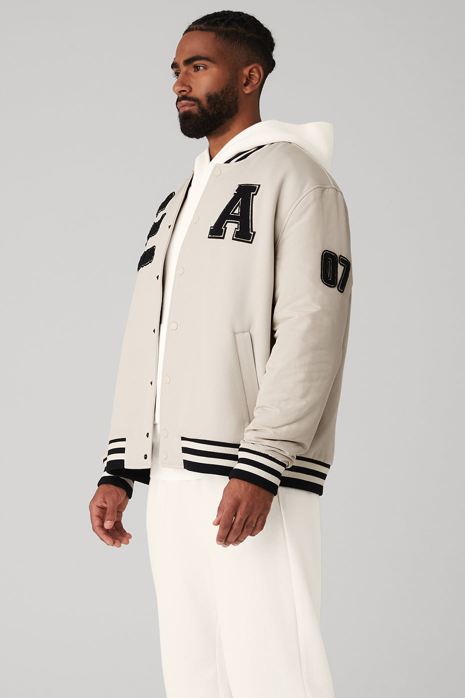 Model wearing the varsity jacket, highlighting its fit and style.