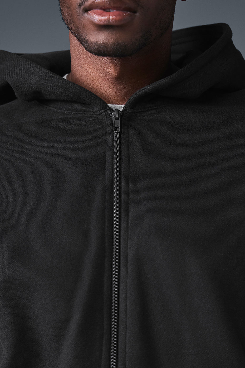 Model wearing oversized zip hoodie in urban setting