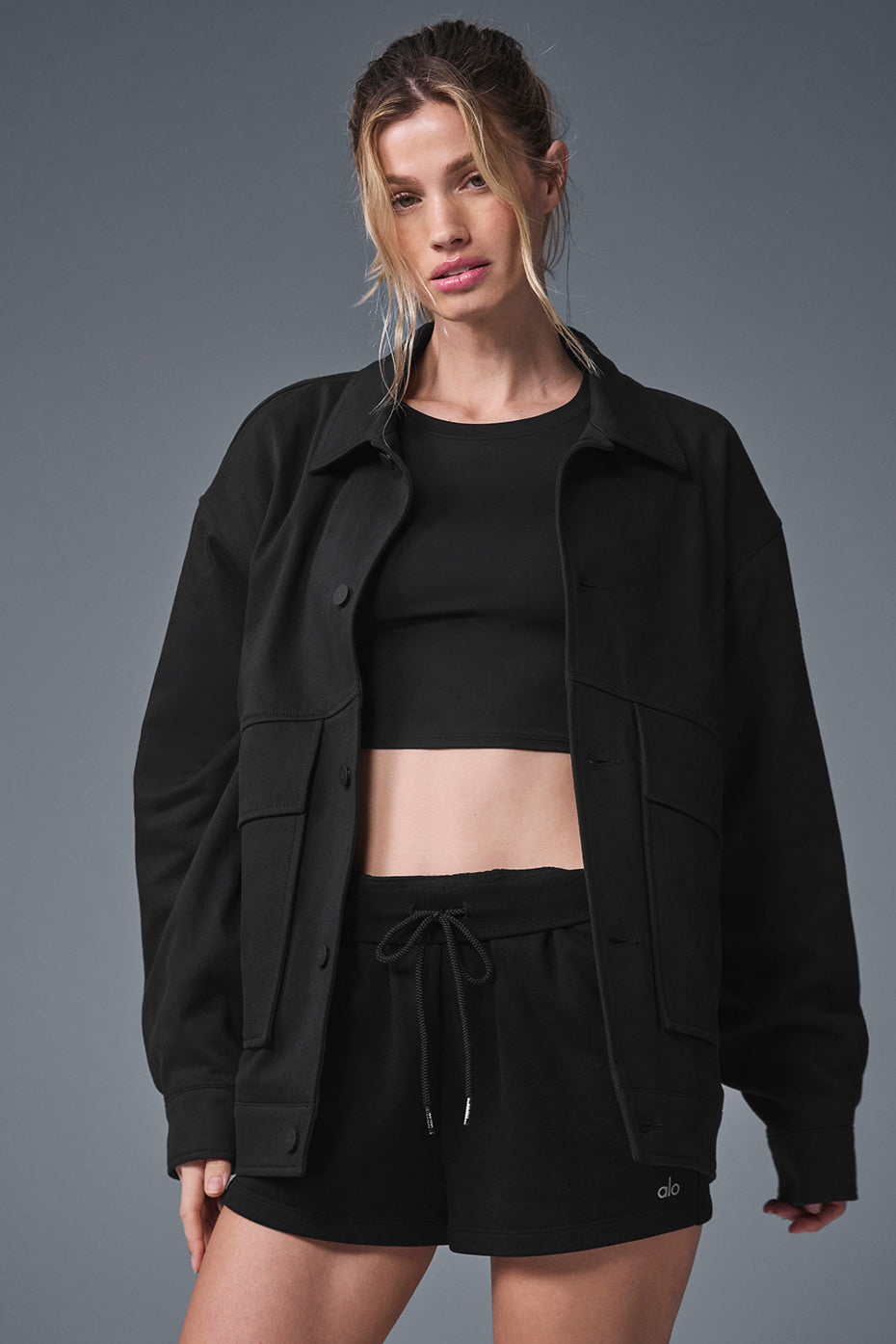 Front-facing view of the unisex jacket styled with denim against an LA urban backdrop