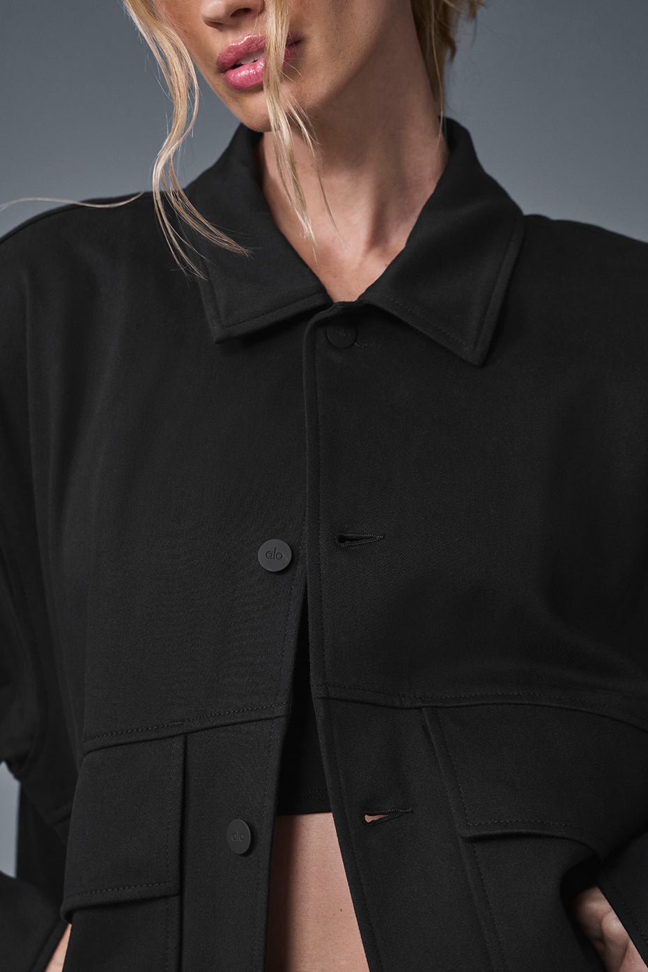 Side view showing the jackets oversized pockets and boxy silhouette on a male model