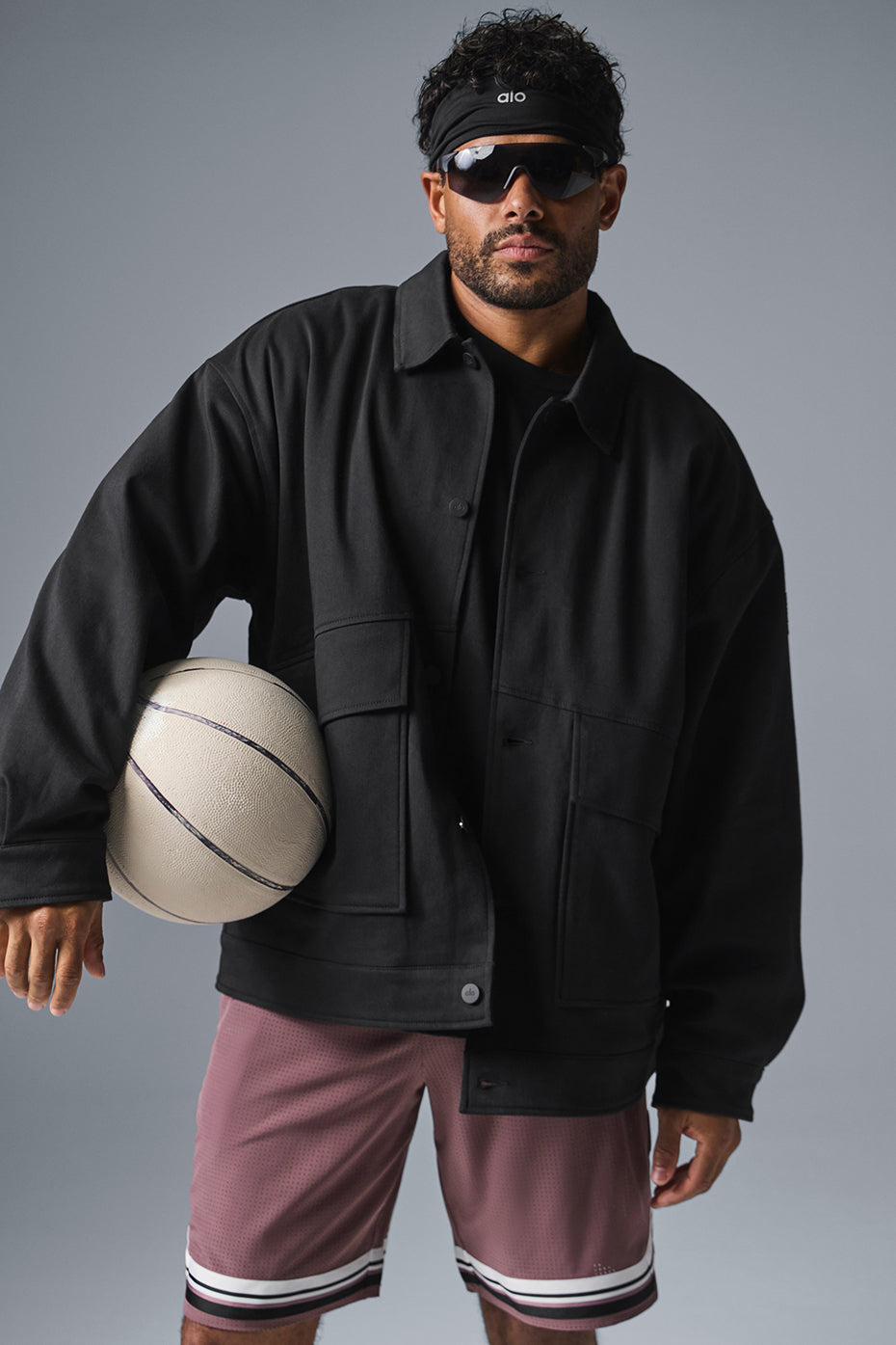 Front view of the black utility jacket showcasing its relaxed fit and oversized pockets.