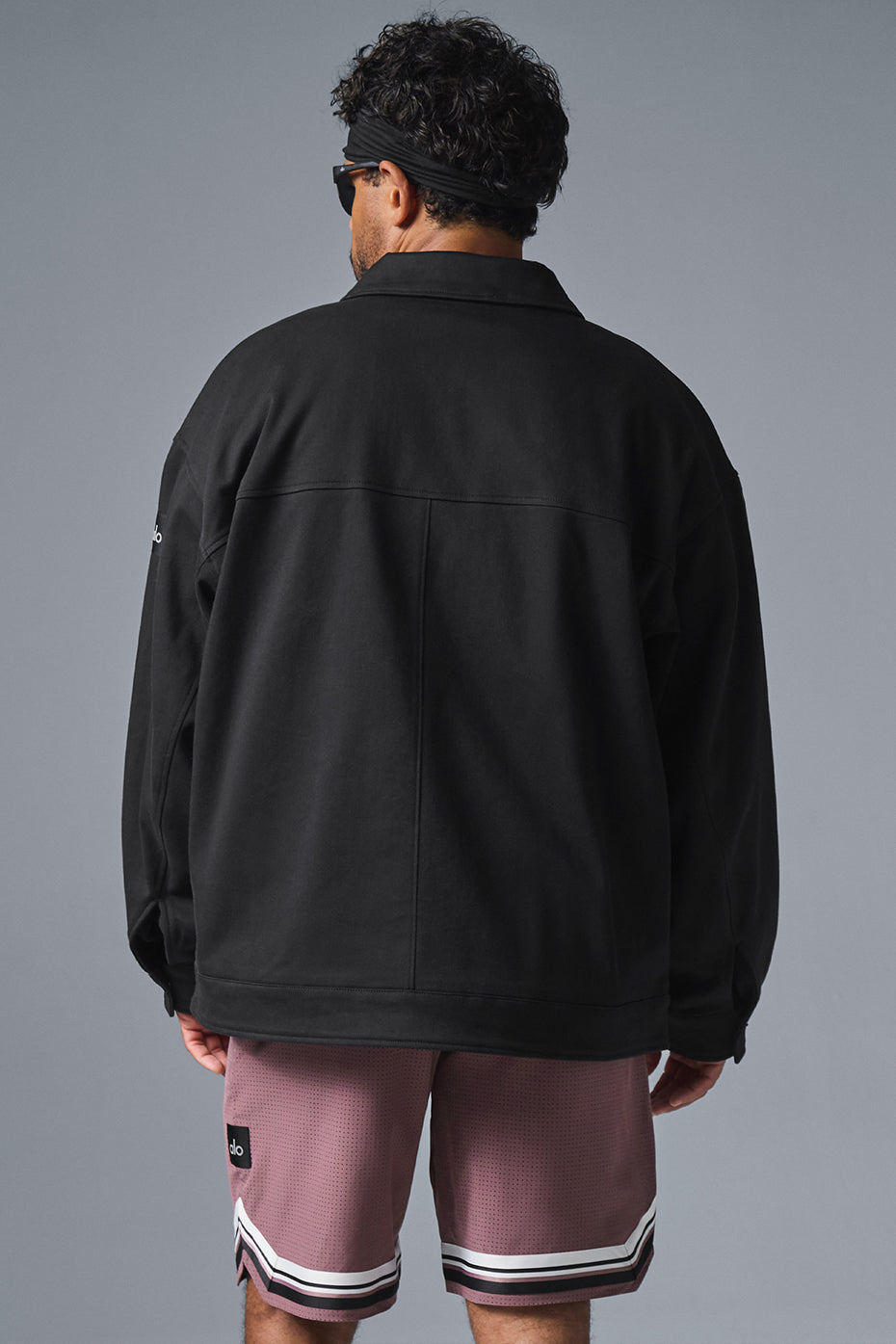 Side view of the unisex utility jacket, highlighting the matte buttons and collar.