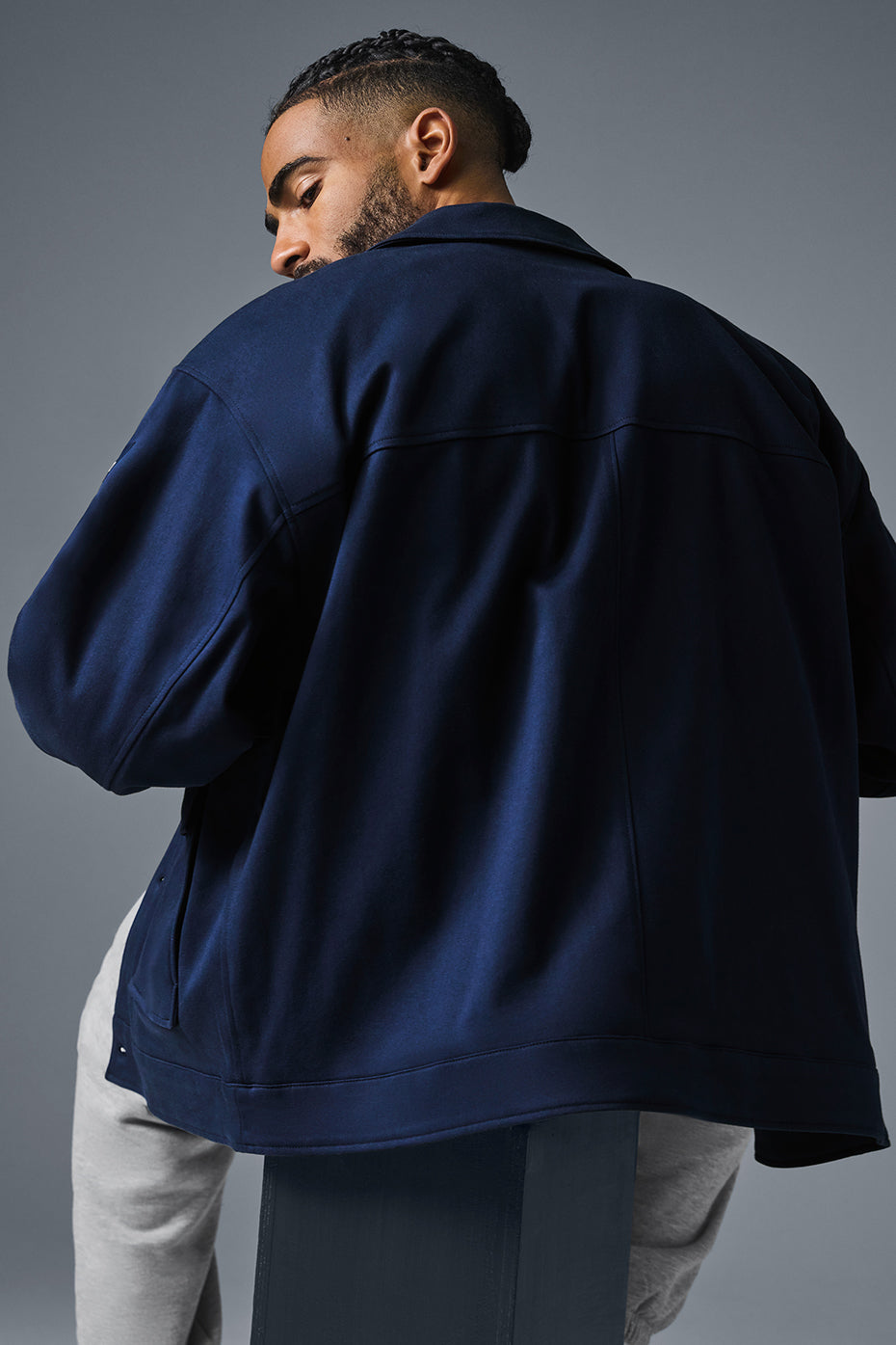 Model wearing the unisex utility jacket in a casual setting