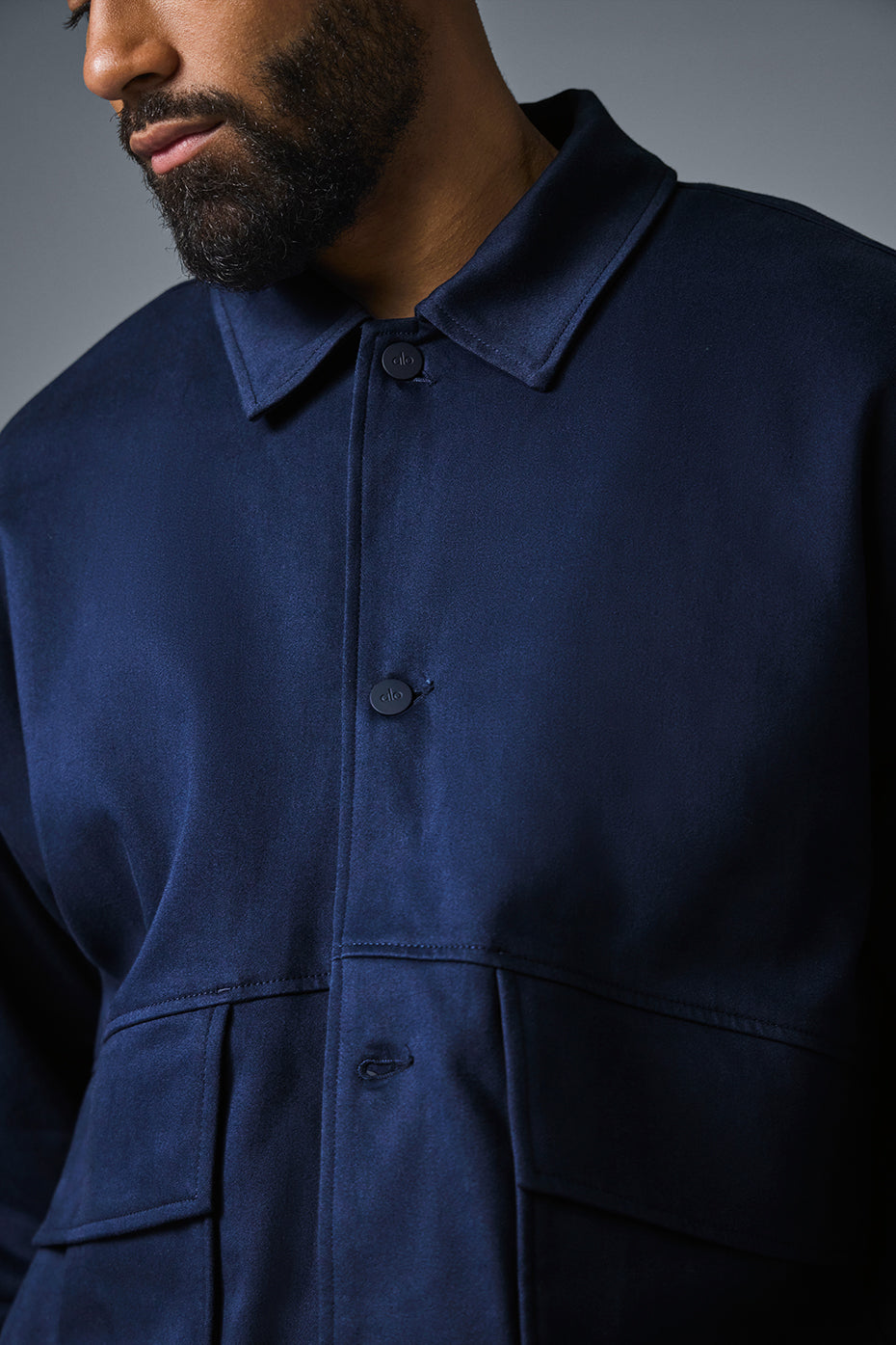 Close-up of matte buttons and point collar on the utility jacket