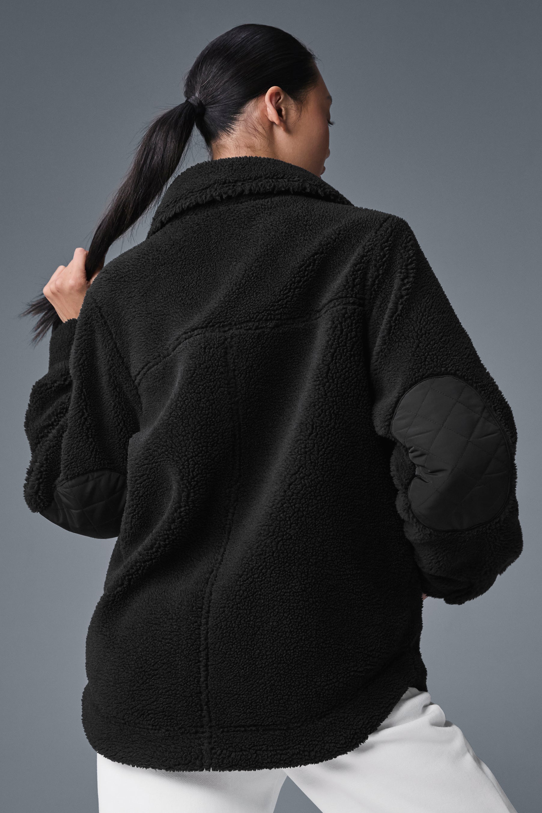 Model wearing Sherpa Edge shacket layered over a long sleeve in outdoor setting
