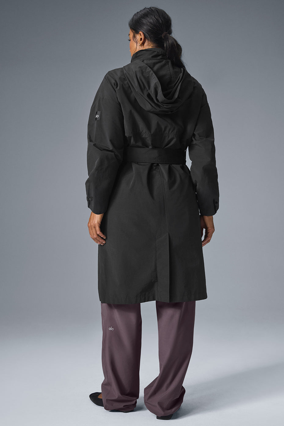 Full-length view of a woman showing the calf-grazing hem of the trench coat