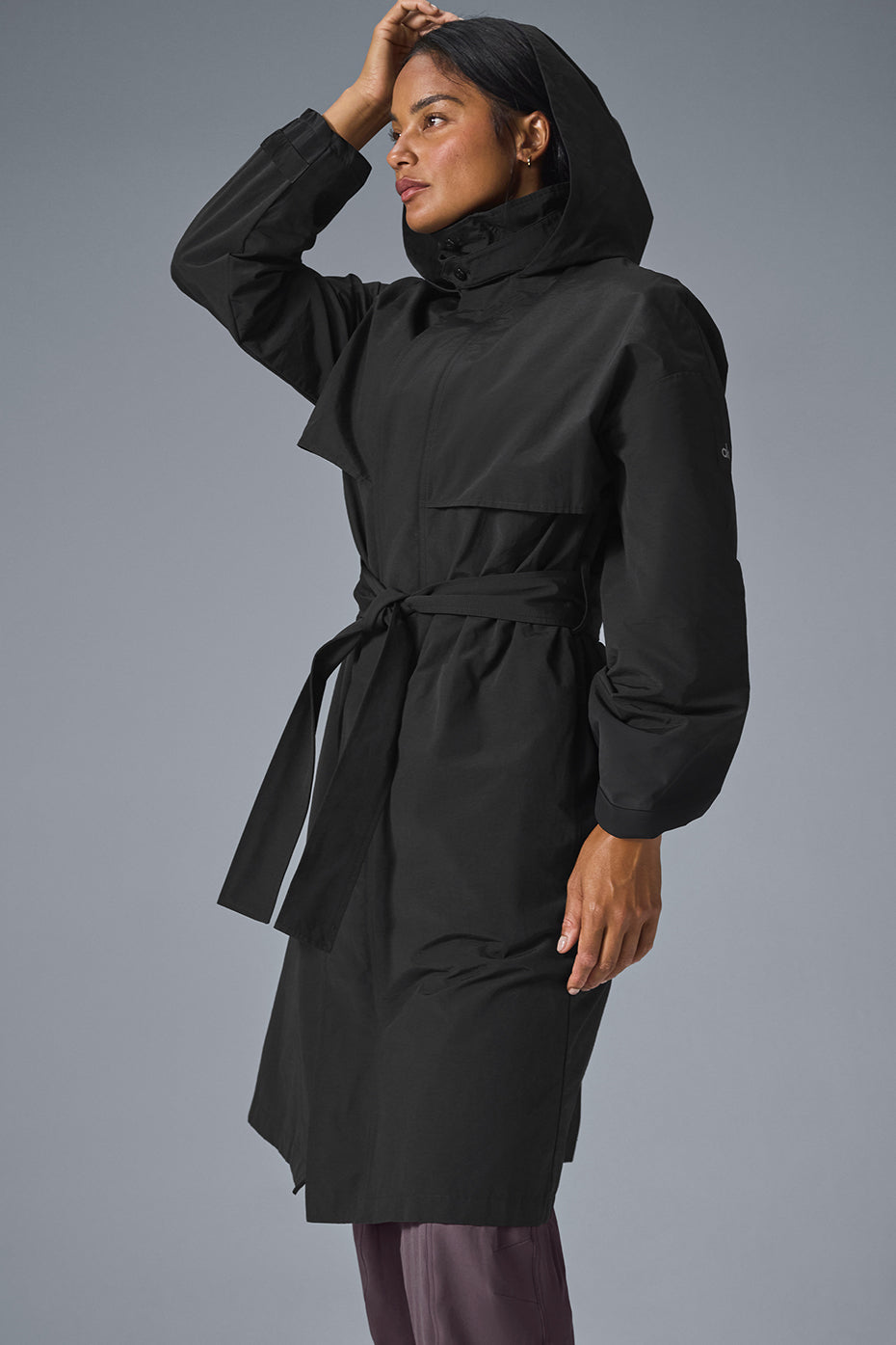 Close-up of a black trench coat collar with zipper detail