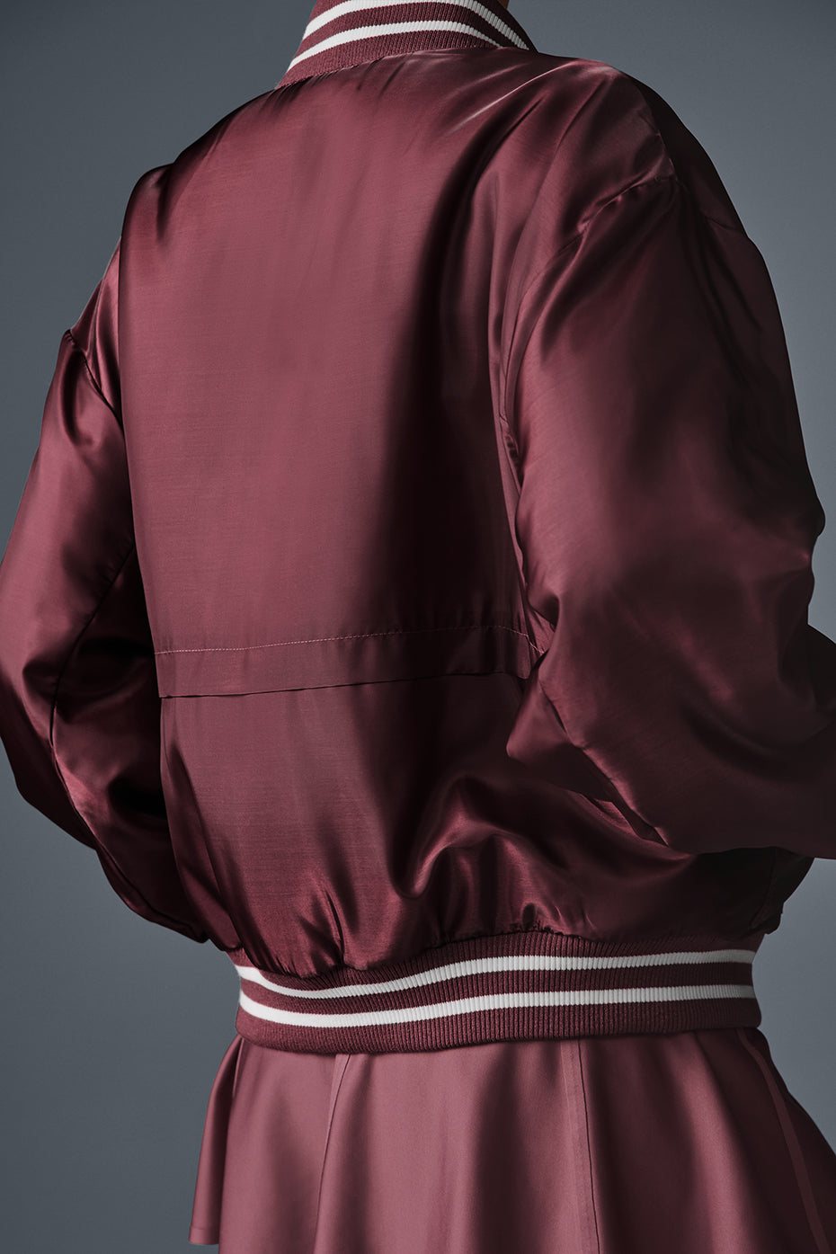 Back view of the Afterglow varsity jacket highlighting its fit.