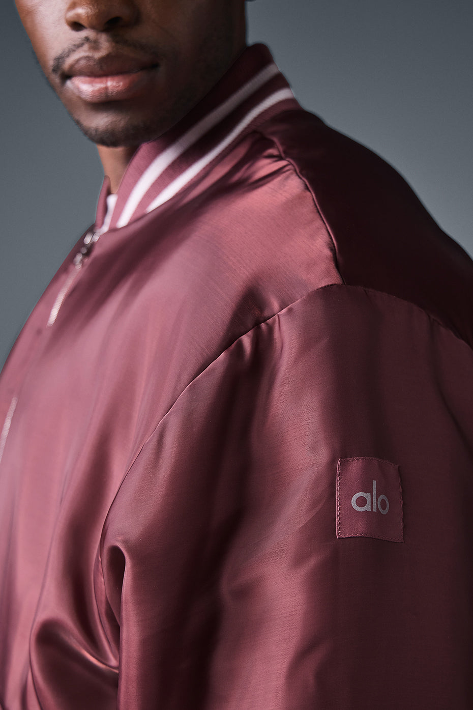 Side angle of the mens varsity jacket, perfect for layering in cooler weather.